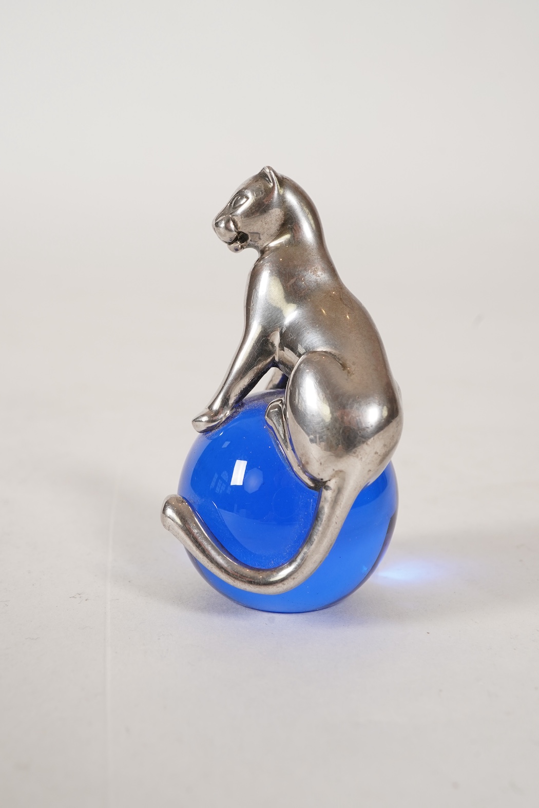 A recent Cartier paperweight, modelled as a panther upon a blue glass sphere
